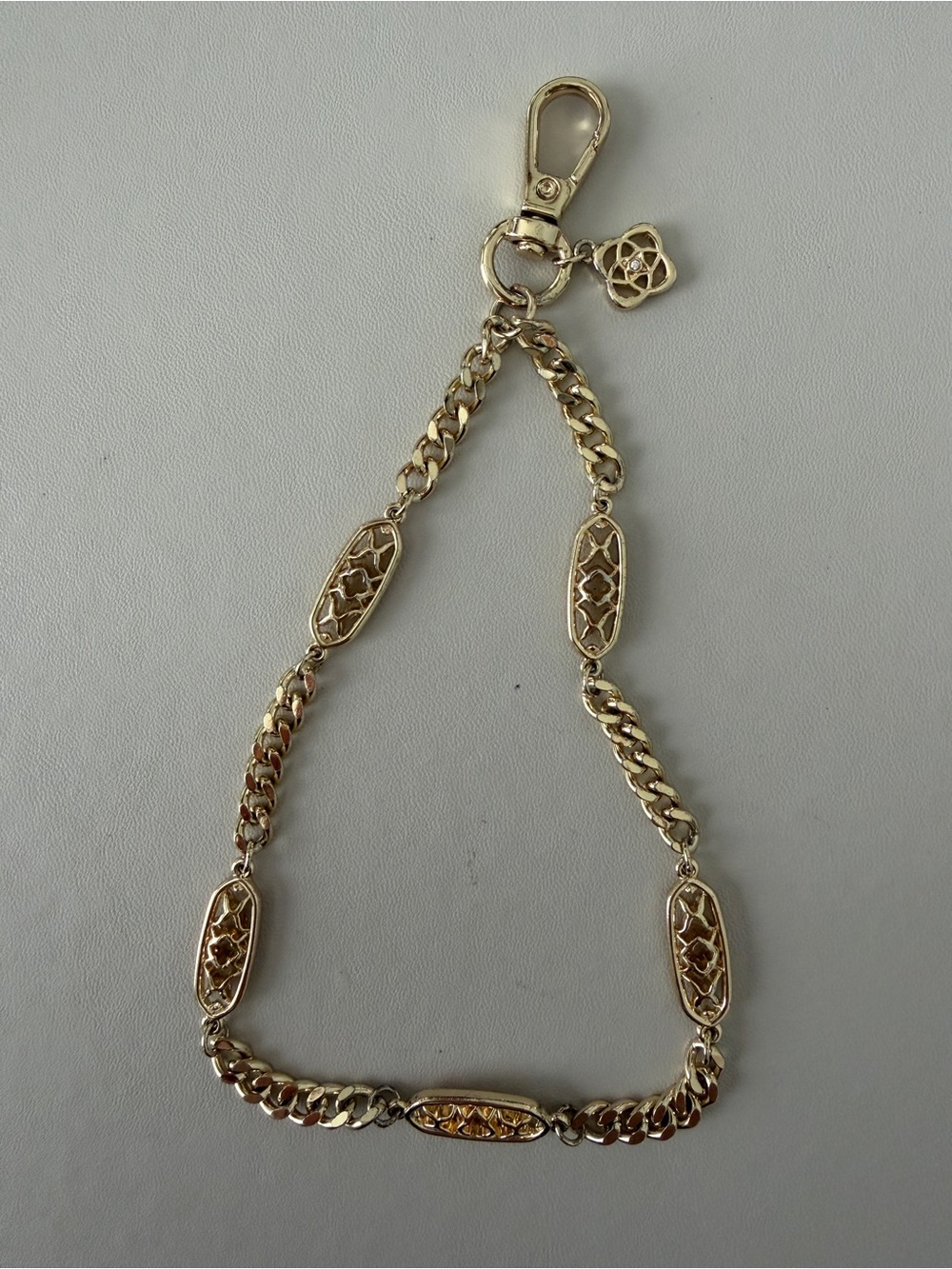 Gold-Tone Linked phone wristlet with Decorative Medallions - Kendra Scott